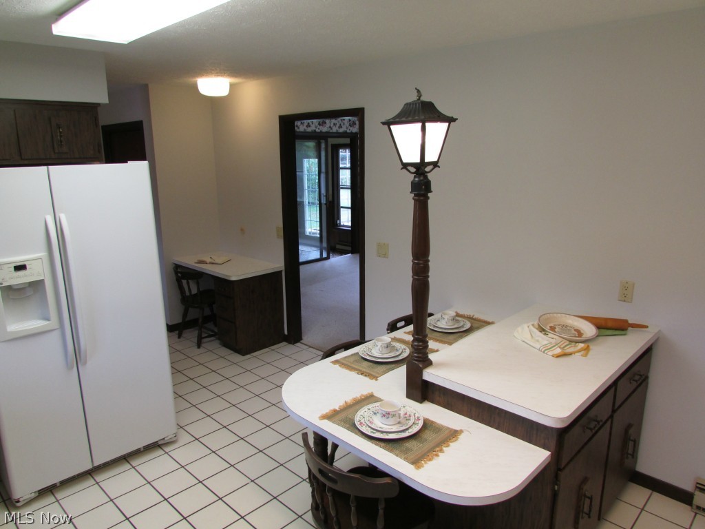 12044 Huntoon Road Painesville, OH 44077 - Photo 7 of 25 The center island has additional storage space and seating for three. Perfect for Holiday baking, buffet serving or informal meals.