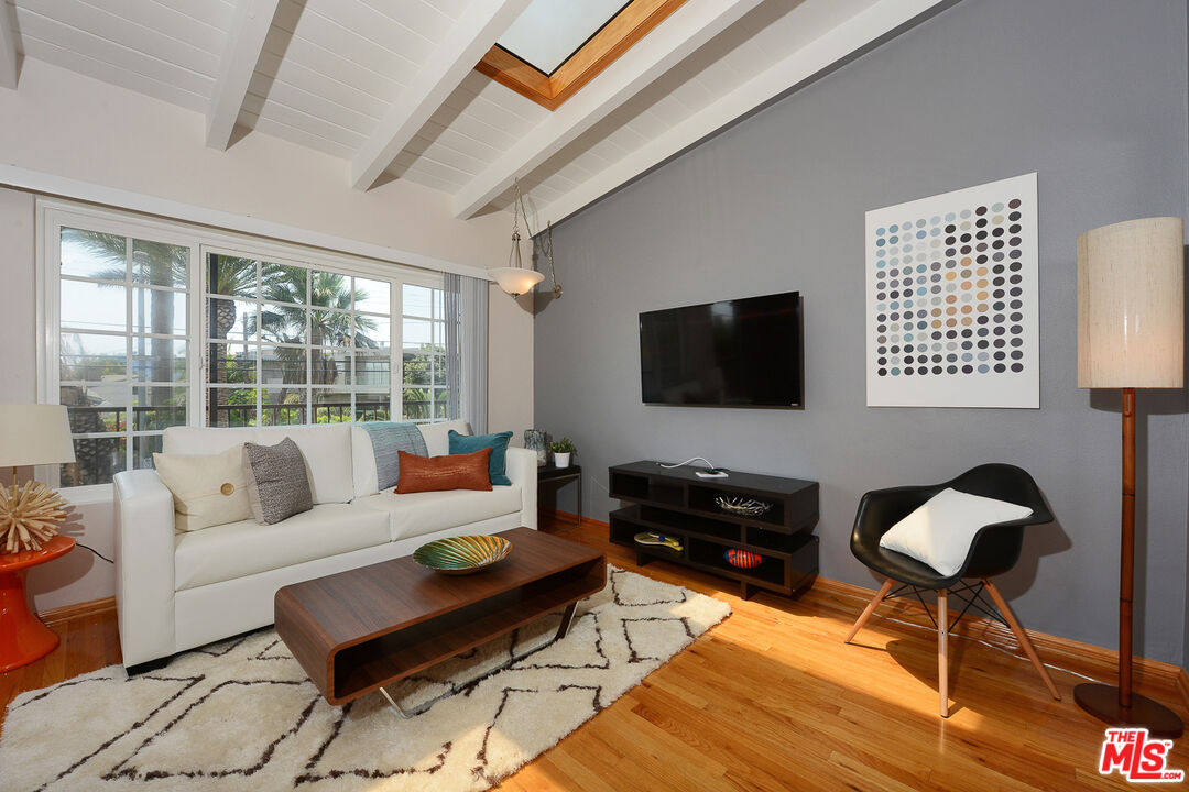 313 Mildred Avenue, Unit 19 Venice, CA 90291 - Photo 1 of 1 a living room with furniture and a flat screen tv