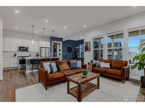 a living room with furniture and kitchen view