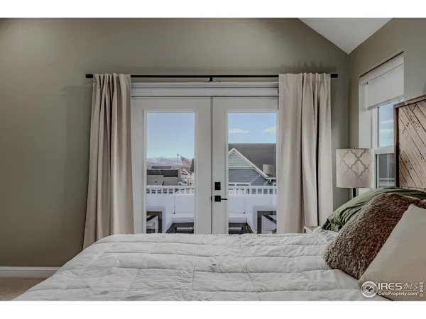 a bedroom with a bed and a chair