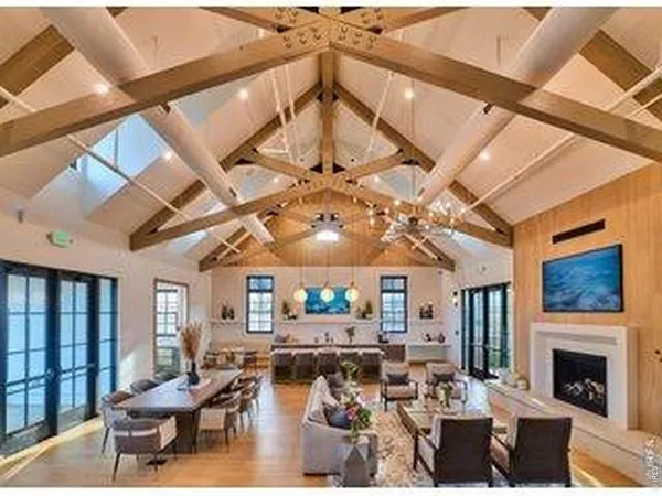 a living room with fireplace furniture and a large window