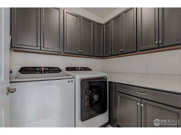 a kitchen with a dining table chairs sink and cabinets