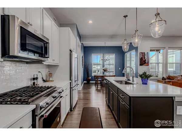 a kitchen with a stove a sink and a microwave