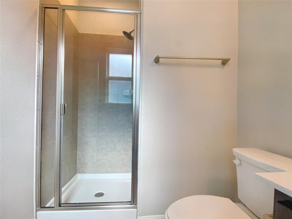 8901 Panhandle Drive Austin, TX 78747 - Photo 17 of 21 Shower enclosure with clear glass door, chrome frame, and tile surround