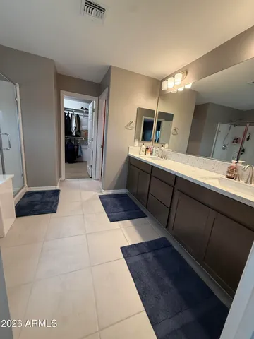 a large bathroom with a sink and a mirror