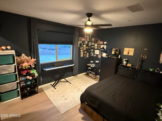 a bedroom with furniture and a flat screen tv