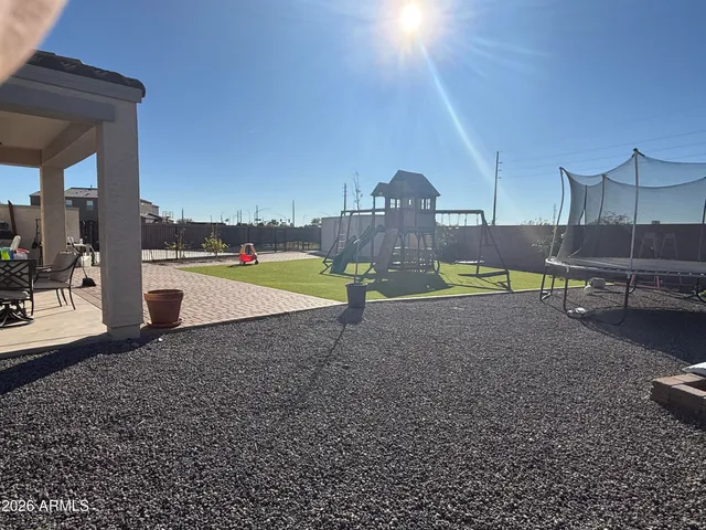 a view of a swimming pool with a yard
