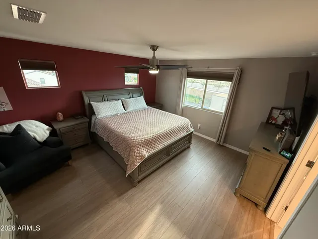 a bed sitting in a bedroom next to a window