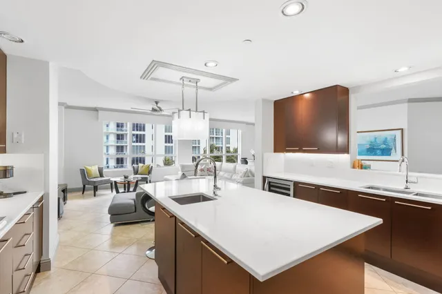 a large kitchen with kitchen island granite countertop a large window and stainless steel appliances