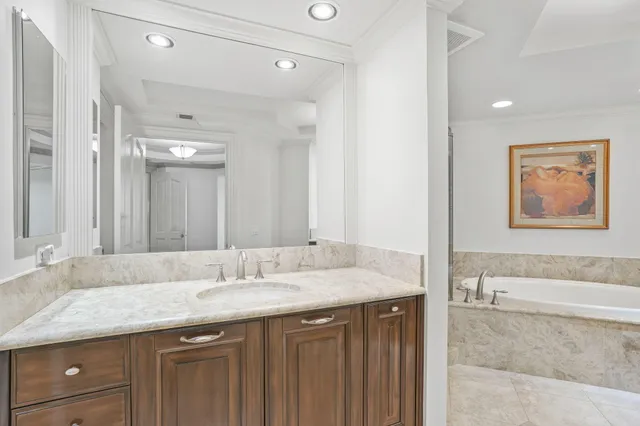 a bedroom with a large bed and a flat tv screen on dresser