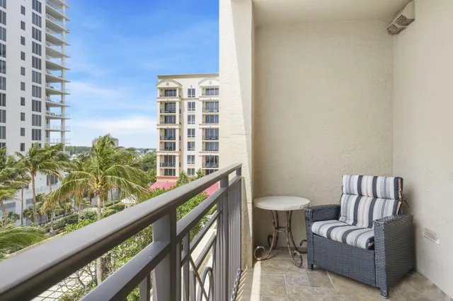 a bedroom with a bed and flat tv screen on the dresser