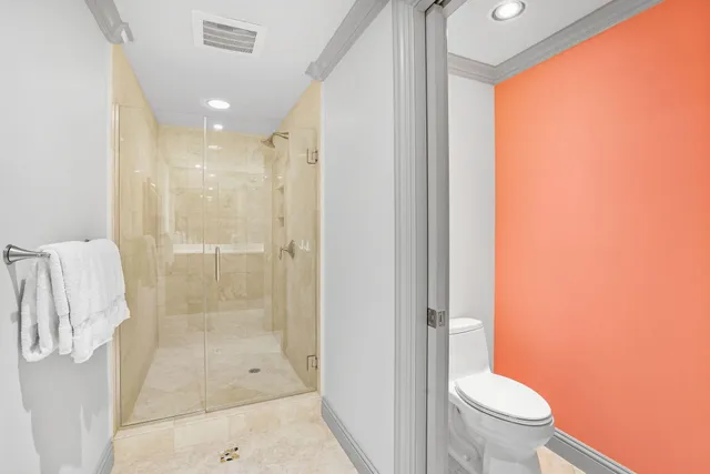 a bedroom with a large bed and a flat tv screen on dresser