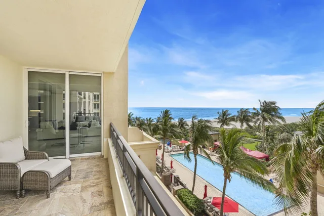 a living room filled with furniture and a floor to ceiling window