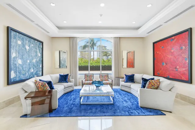 a bedroom with furniture and large window