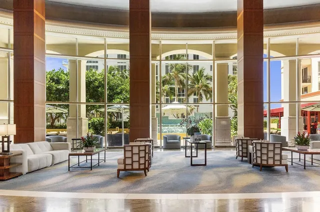 a room with gym equipment and large windows