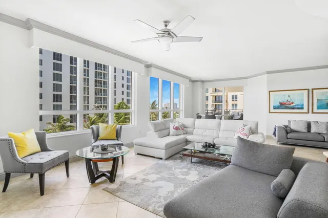 a living room with furniture and a potted plant