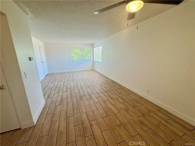 a view of a room with wooden floor