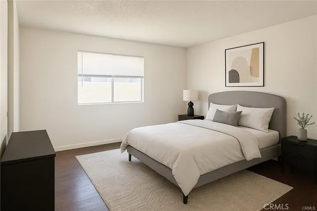 a bedroom with bed and a window