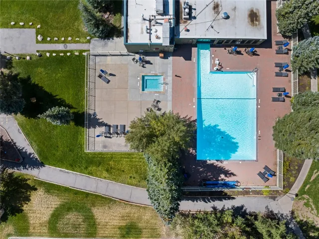 an aerial view of residential houses with outdoor space and swimming pool