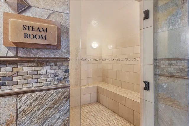 a bathroom with a shower and a sink