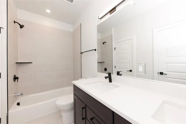 a bathroom with a tub sink toilet and a mirror