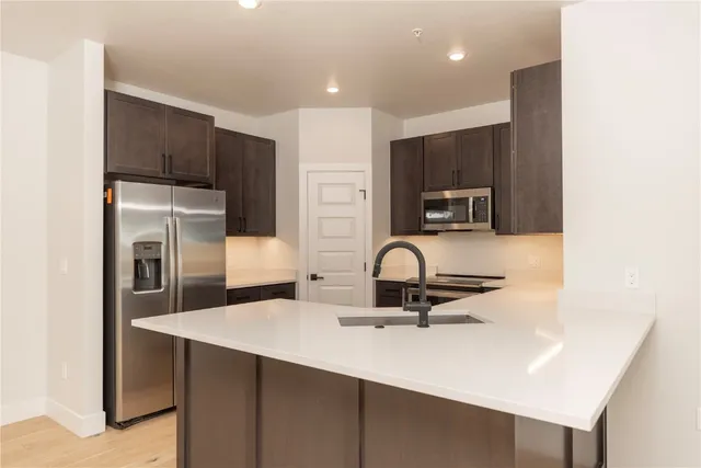 a kitchen with a refrigerator and a sink