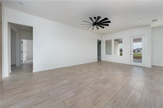 a view of a kitchen with wooden floor and a kitchen