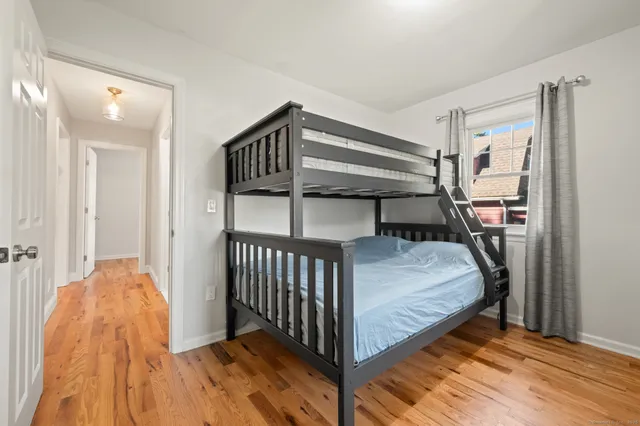 a bedroom with a bed and a book shelf