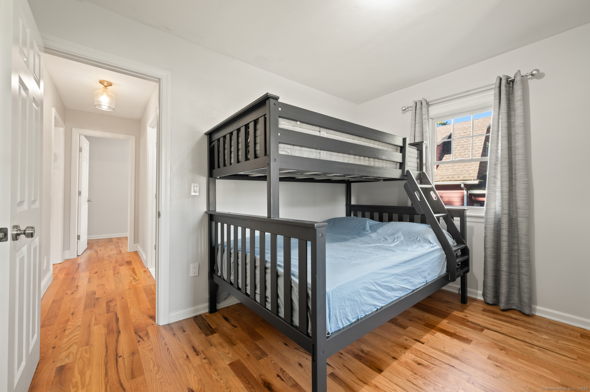 6 Howe Street Milford, CT 06460 - Photo 14 of 32 a bedroom with a bed and a book shelf