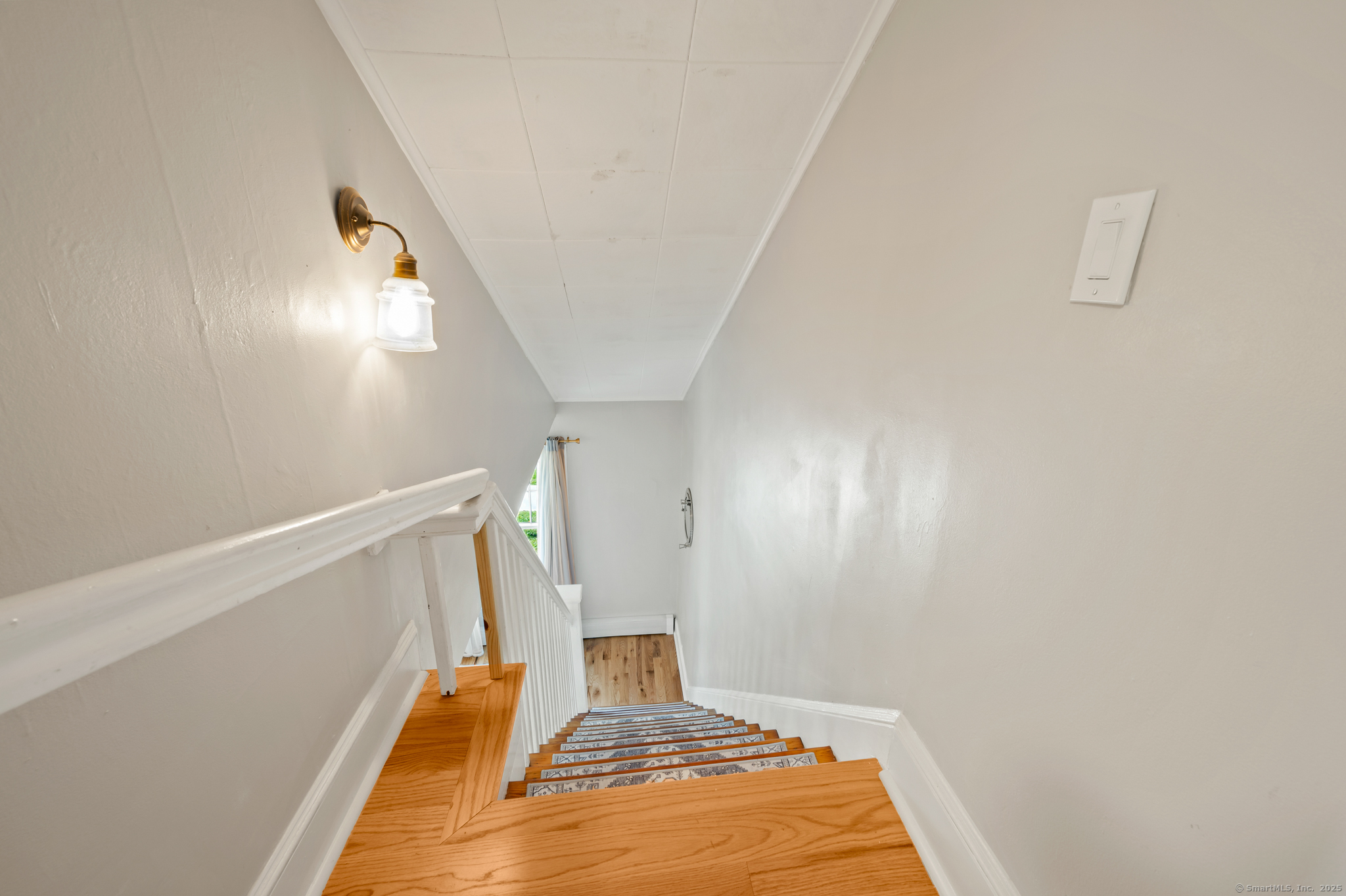 6 Howe Street Milford, CT 06460 - Photo 18 of 32 a bedroom with a bed and wooden floor