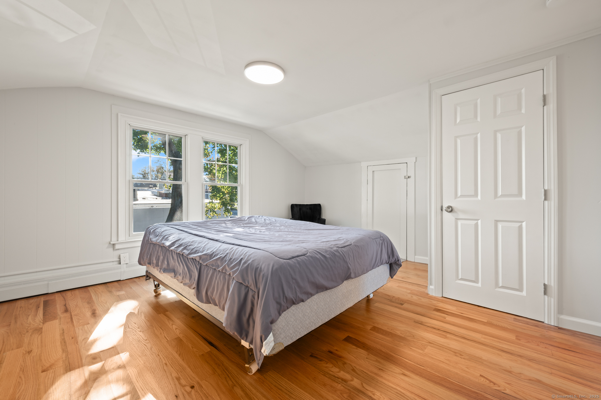 6 Howe Street Milford, CT 06460 - Photo 19 of 32 a bedroom with a bed and wooden floor