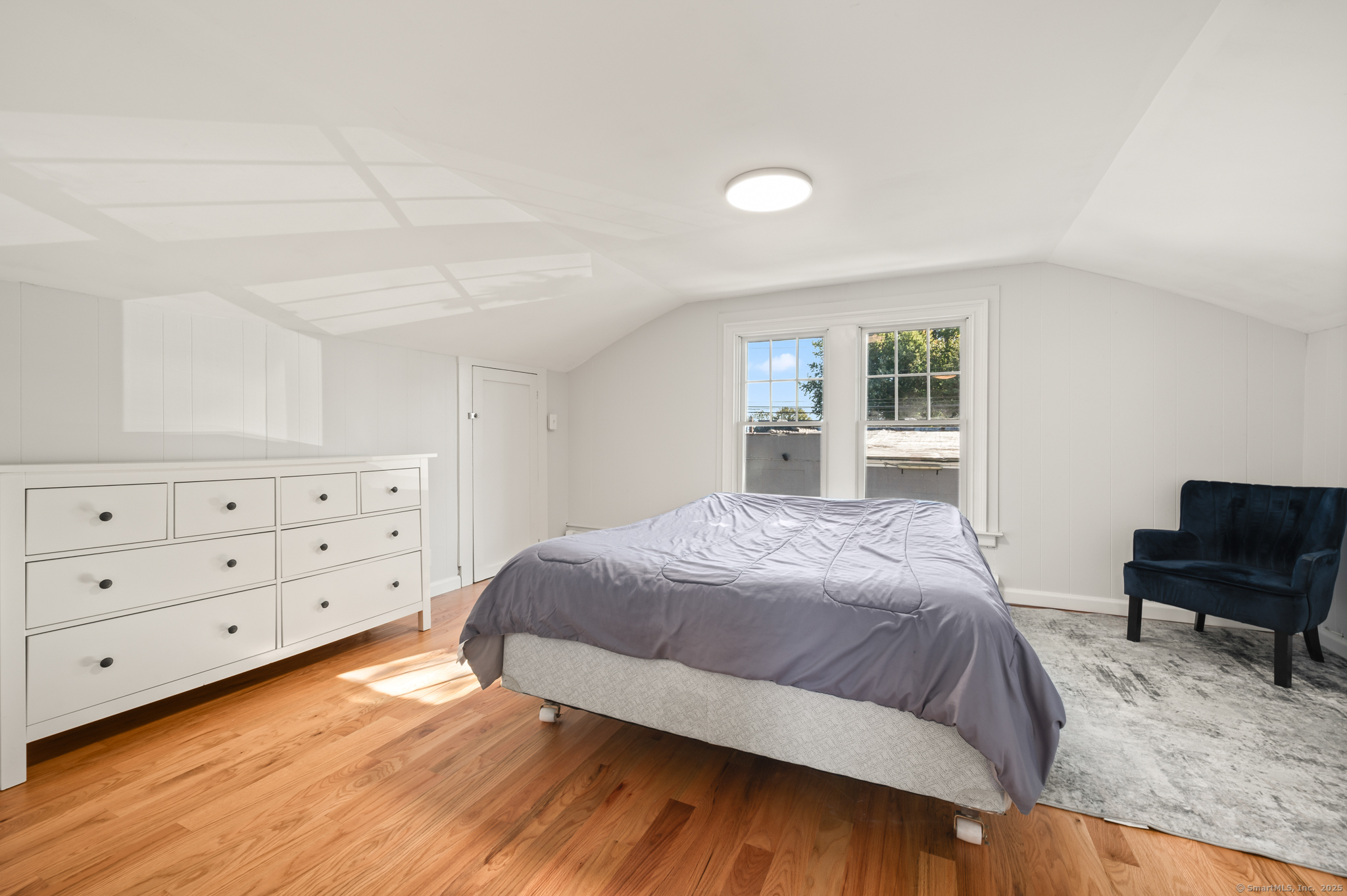 6 Howe Street Milford, CT 06460 - Photo 20 of 32 a bedroom with a bed a dresser and a window