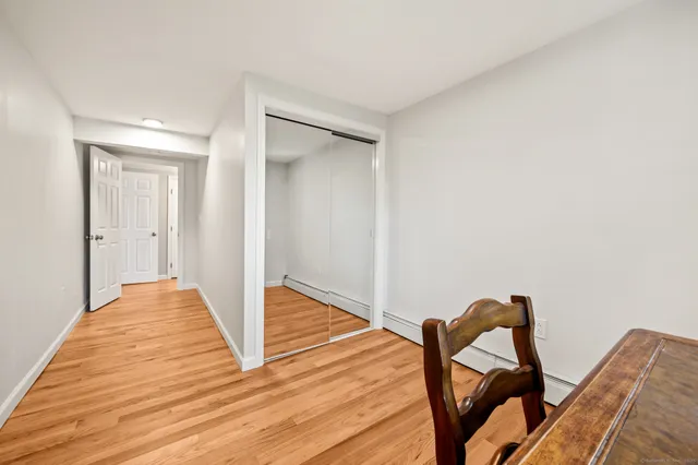 a view of a livingroom with wooden floor and furniture