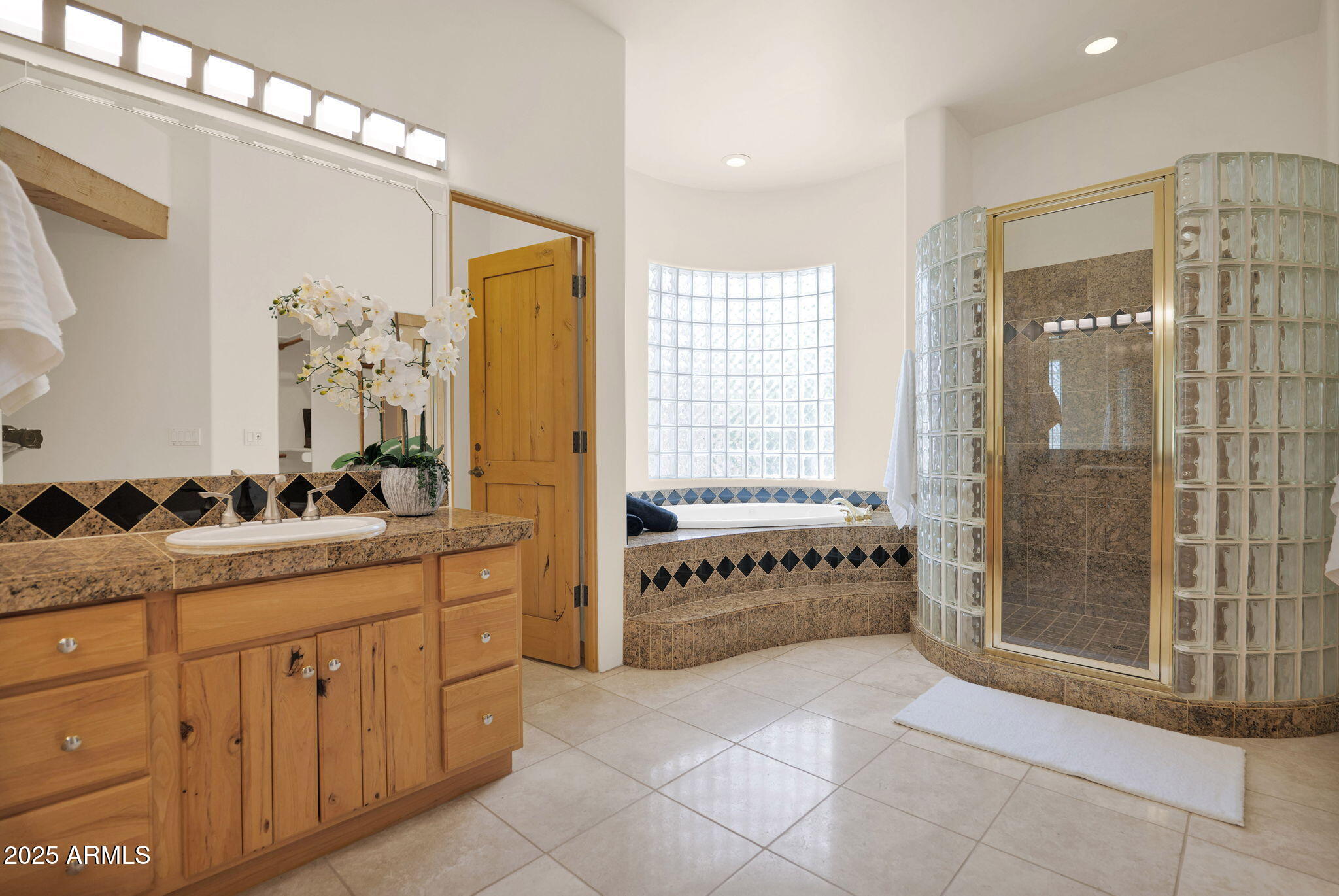 7130 East Saddleback Street, Unit 5 Mesa, AZ 85207 - Photo 27 of 57 a spacious bathroom with a granite countertop sink a mirror and a shower