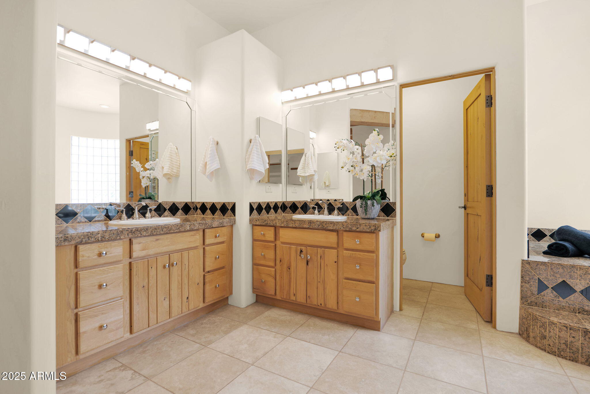 7130 East Saddleback Street, Unit 5 Mesa, AZ 85207 - Photo 28 of 57 a spacious bathroom with a granite countertop sink and a mirror