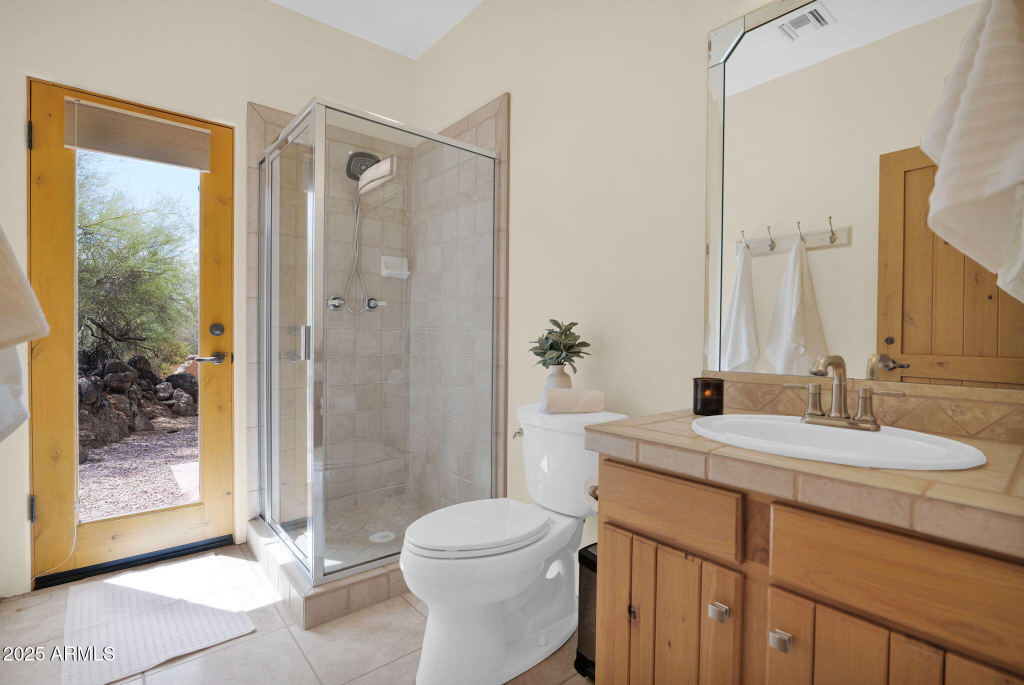 7130 East Saddleback Street, Unit 5 Mesa, AZ 85207 - Photo 34 of 57 a bathroom with a granite countertop sink toilet a mirror a vanity and shower