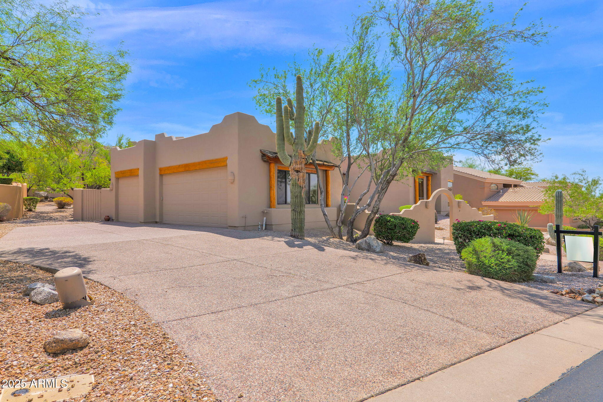 7130 East Saddleback Street, Unit 5 Mesa, AZ 85207 - Photo 42 of 57 a front view of a house with a yard and garage
