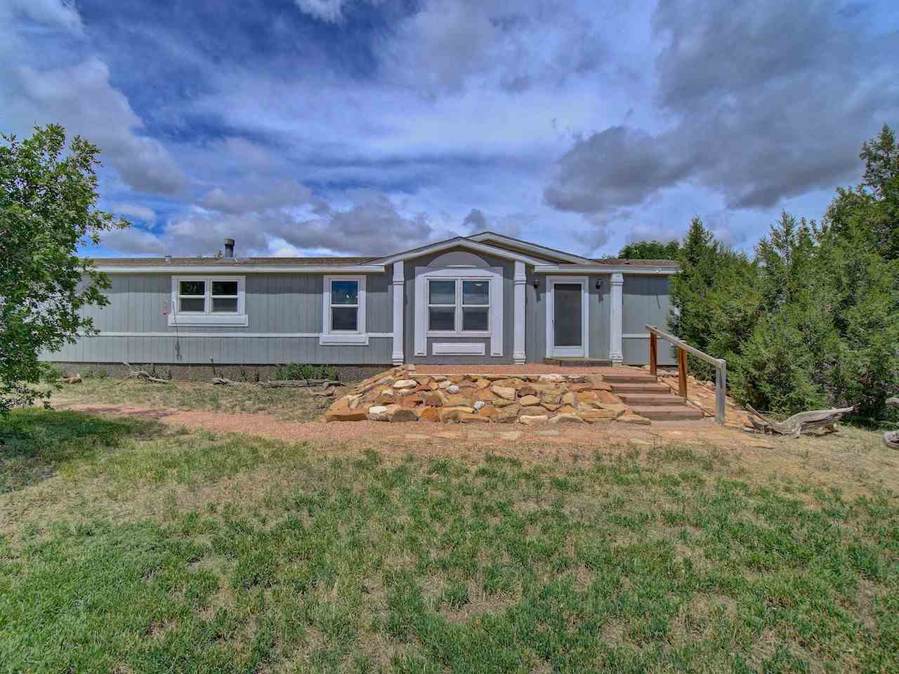 1317 Saddle Ridge Road Loma, CO 81524 - Photo 1 of 32 front view of house with a yard
