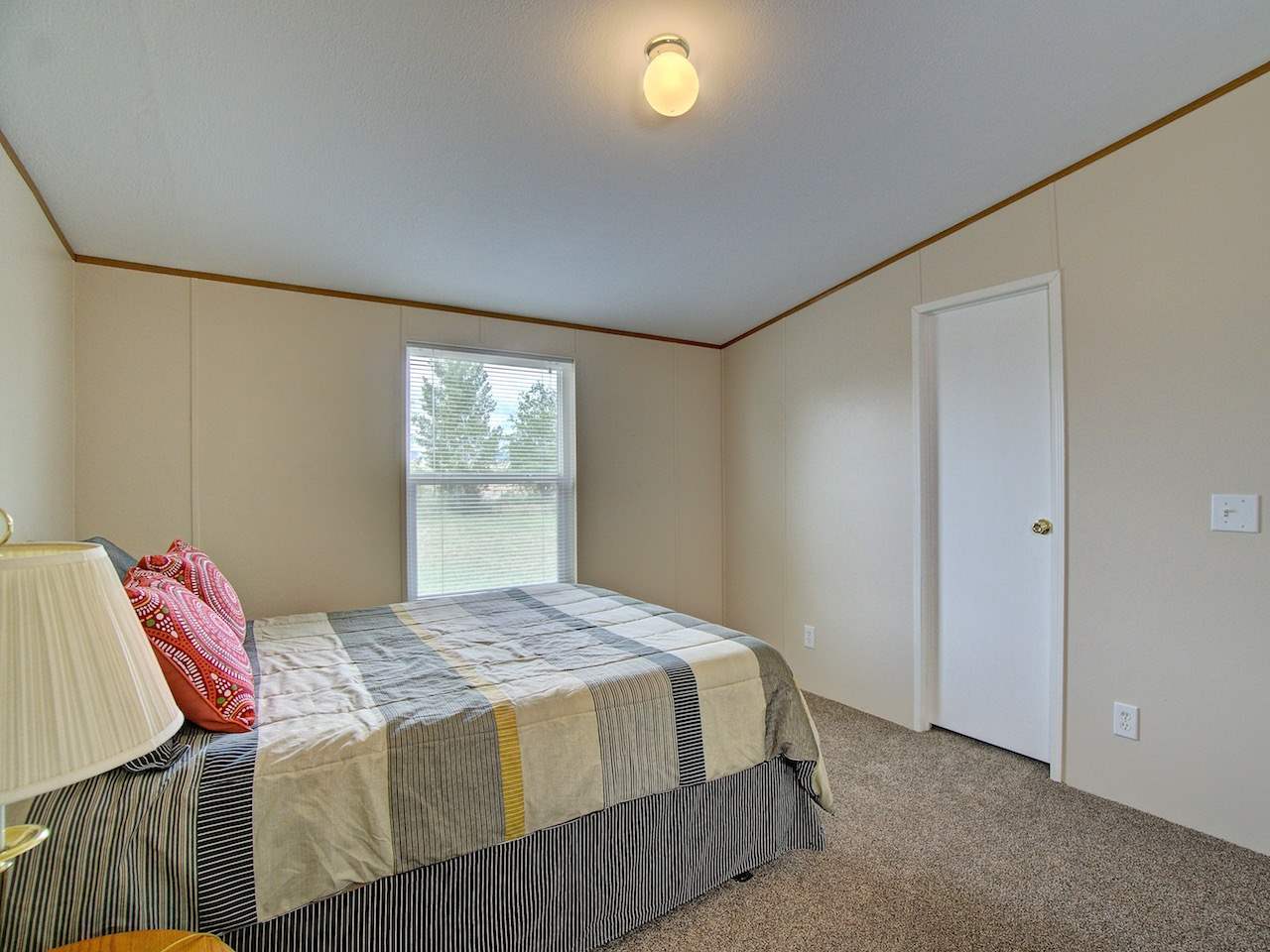 1317 Saddle Ridge Road Loma, CO 81524 - Photo 12 of 32 a bedroom with a bed and a window