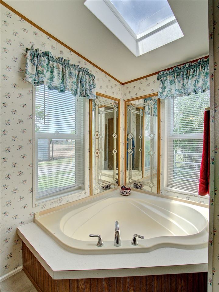 1317 Saddle Ridge Road Loma, CO 81524 - Photo 19 of 32 a bath tub sitting in a bathroom next to a window