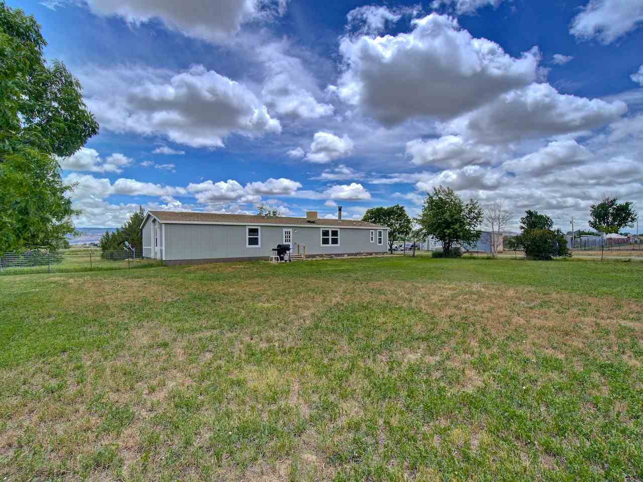 1317 Saddle Ridge Road Loma, CO 81524 - Photo 25 of 32 a view of a big yard with houses