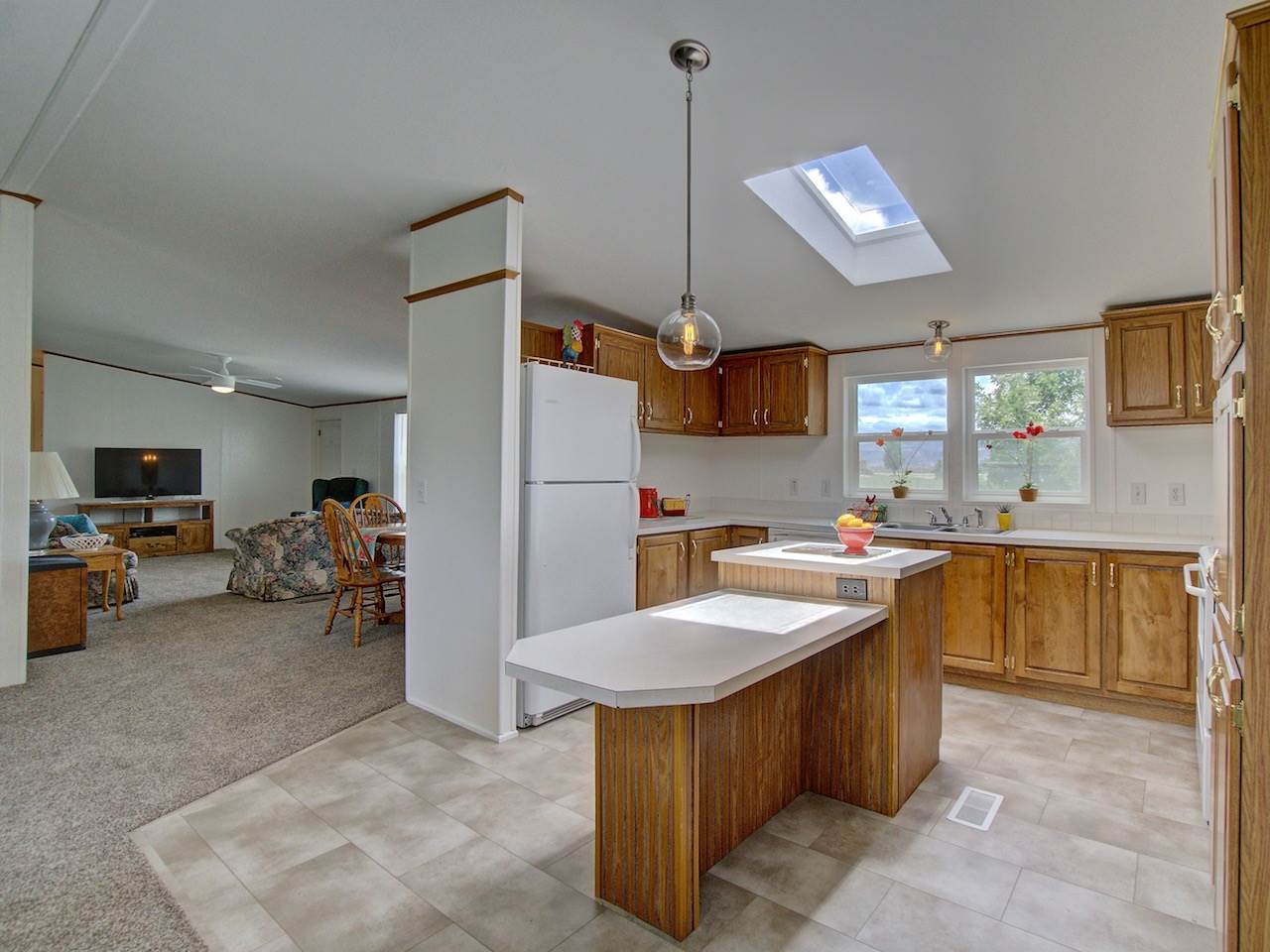 1317 Saddle Ridge Road Loma, CO 81524 - Photo 5 of 32 a kitchen with sink a counter and chairs