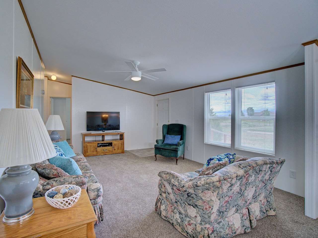 1317 Saddle Ridge Road Loma, CO 81524 - Photo 8 of 32 a living room with furniture a flat screen tv and a large window