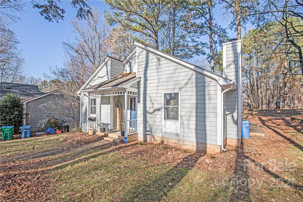 10227 Grand Junction Road Mint Hill, NC 28227 - Photo 3 of 27 a view of a white house with a large tree