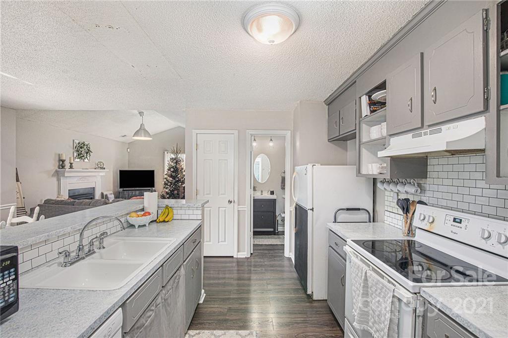 10227 Grand Junction Road Mint Hill, NC 28227 - Photo 23 of 27 a kitchen with a sink stove and refrigerator