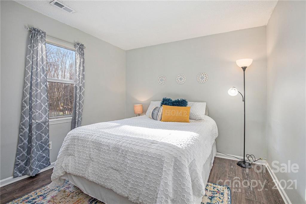 10227 Grand Junction Road Mint Hill, NC 28227 - Photo 8 of 27 a bedroom with a bed and wooden floor