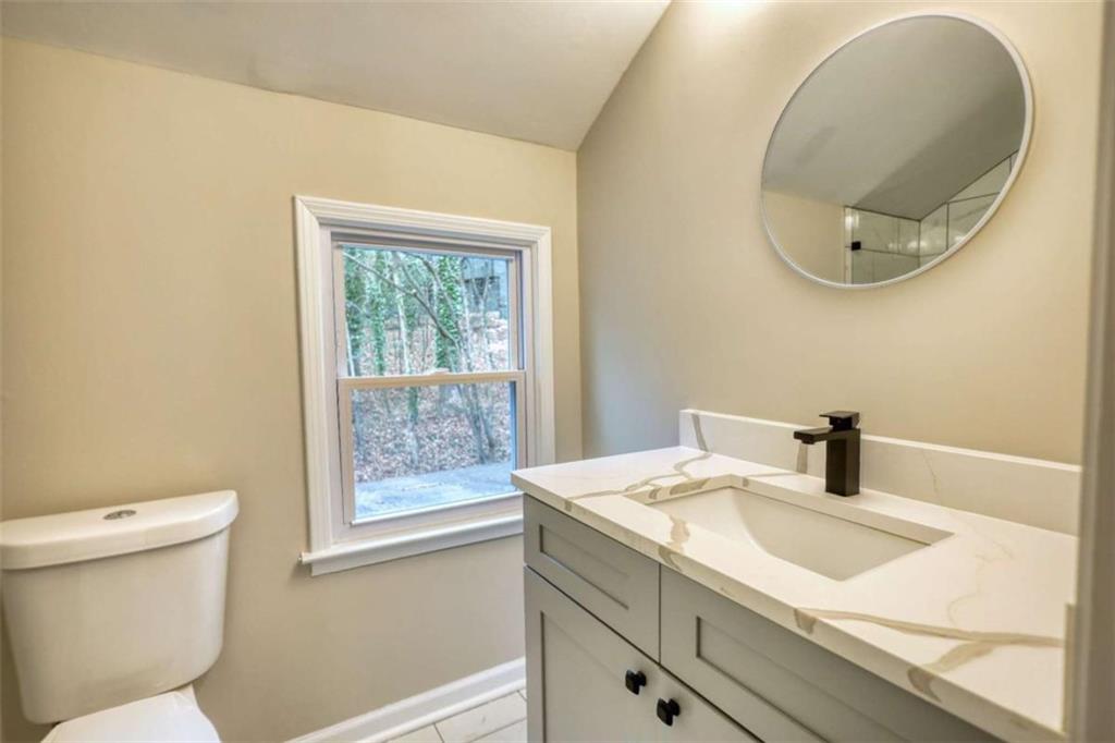 4205 Aberdeen Pass Roswell, GA 30075 - Photo 24 of 53 a bathroom with a sink and a mirror