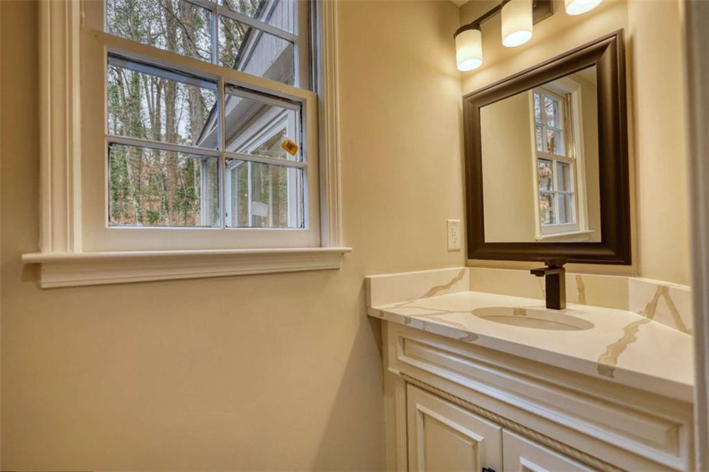 4205 Aberdeen Pass Roswell, GA 30075 - Photo 28 of 53 a bathroom with a sink and a mirror