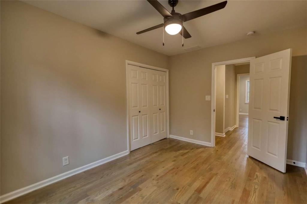 4205 Aberdeen Pass Roswell, GA 30075 - Photo 29 of 53 an empty room with wooden floor and a ceiling fan