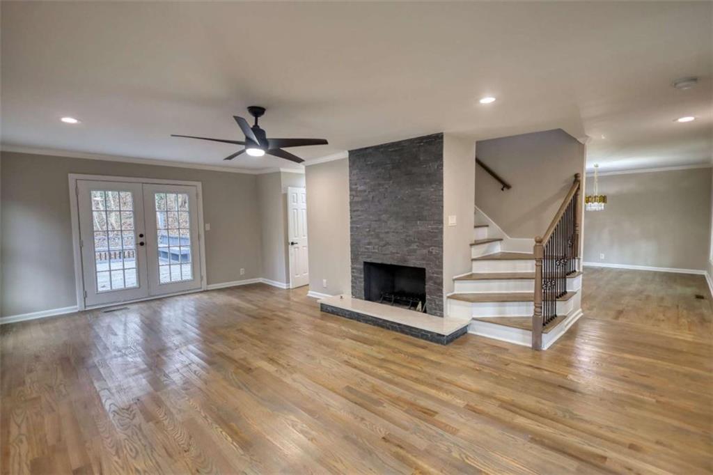 4205 Aberdeen Pass Roswell, GA 30075 - Photo 4 of 53 a view of an empty room with wooden floor and a fireplace